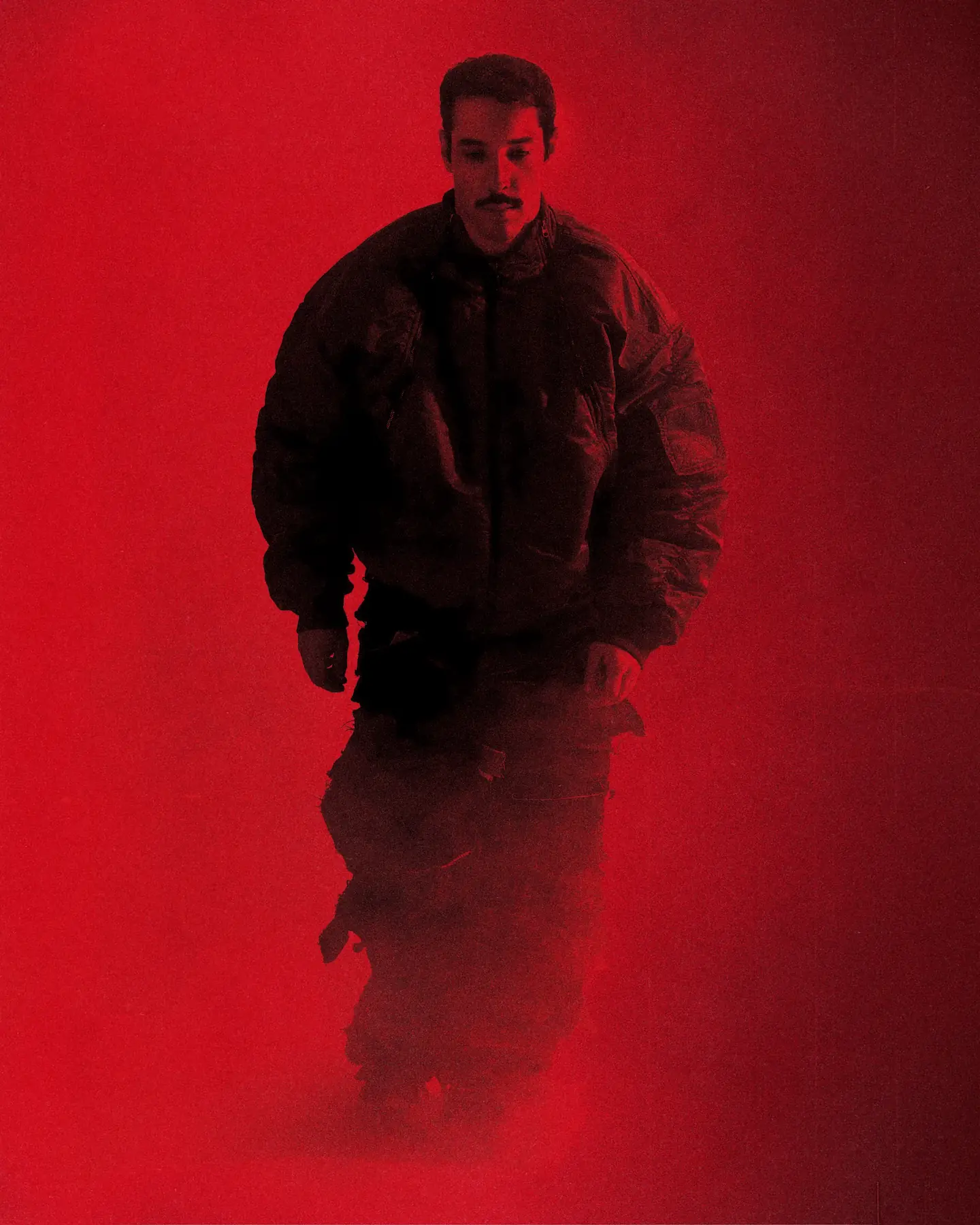 M Le Maudit walking through red smoke in a puffer jacket
