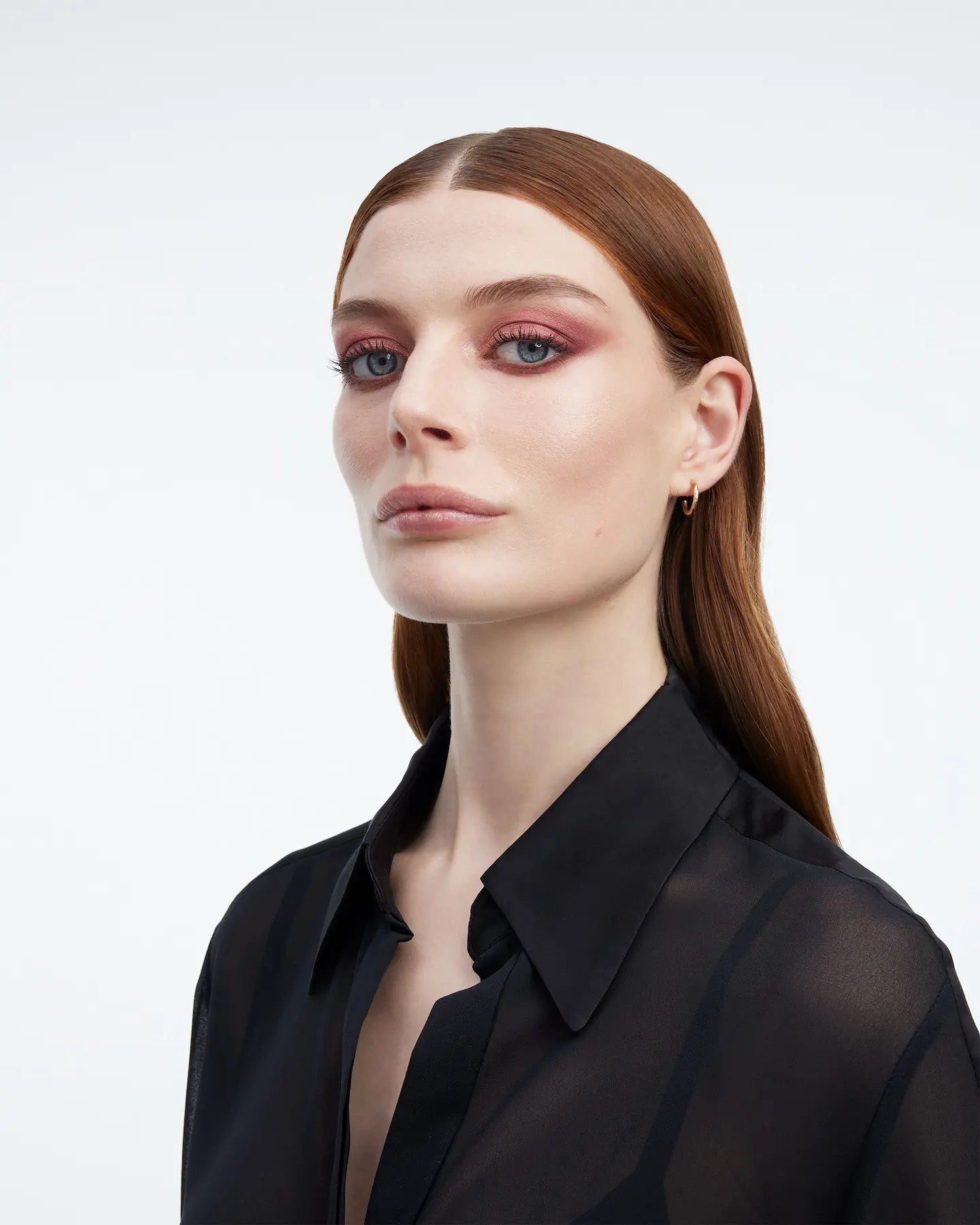 YSL Beauty portrait, model with long auburn hair and pink eyeshadow in a black shirt