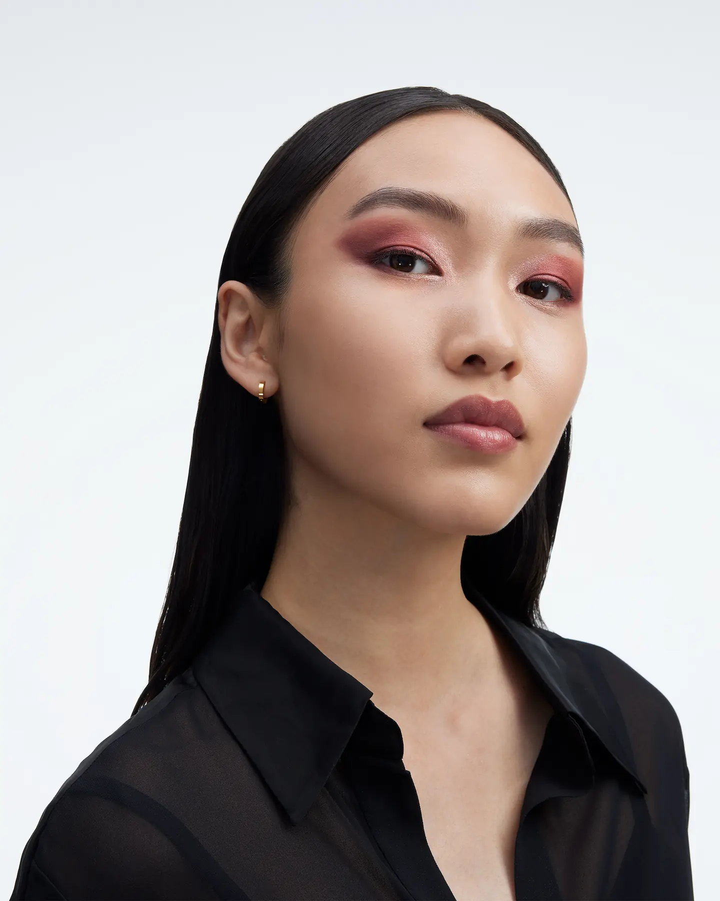YSL Beauty portrait, model with long black hair and rose eyeshadow in a black shirt