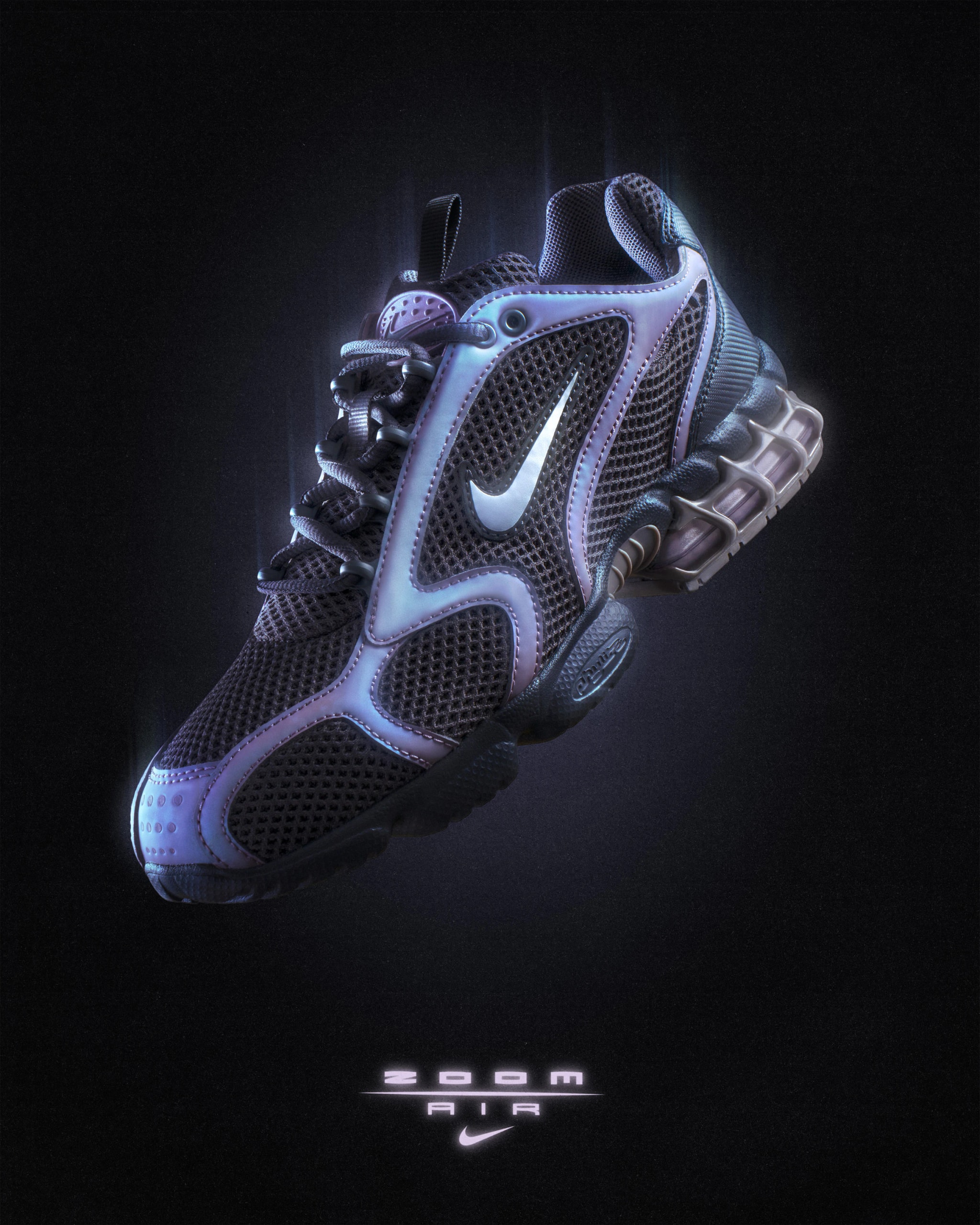 Nike Air Zoom Spiridon Cage 2 with iridescent blue overlays, three-quarter view on black, Zoom Air logo below