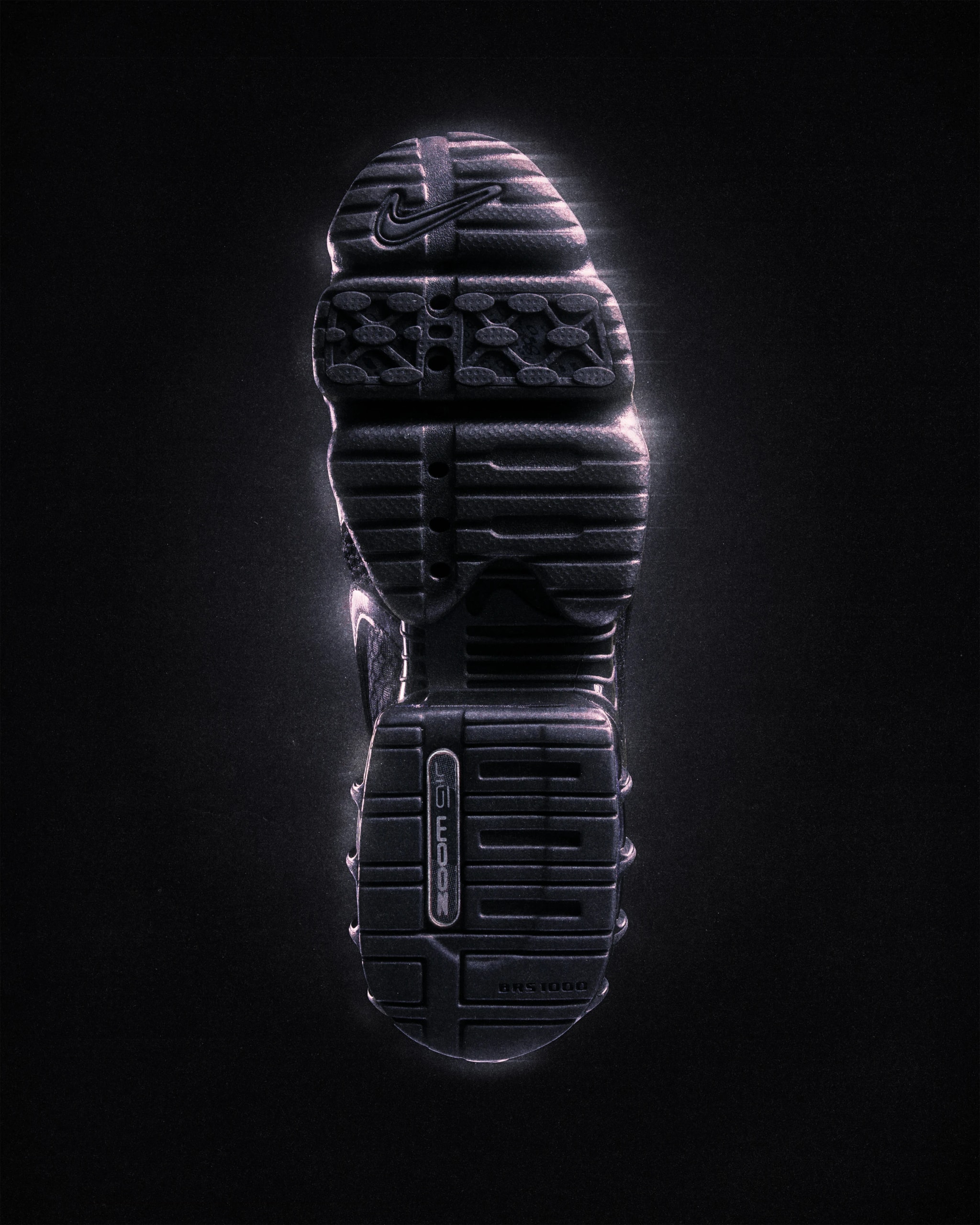 Outsole of the black Nike Air Zoom Spiridon Cage 2, seen from below on black